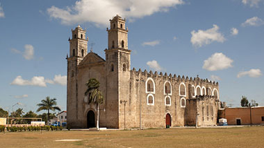 An old church with bright blue sky and white clouds.