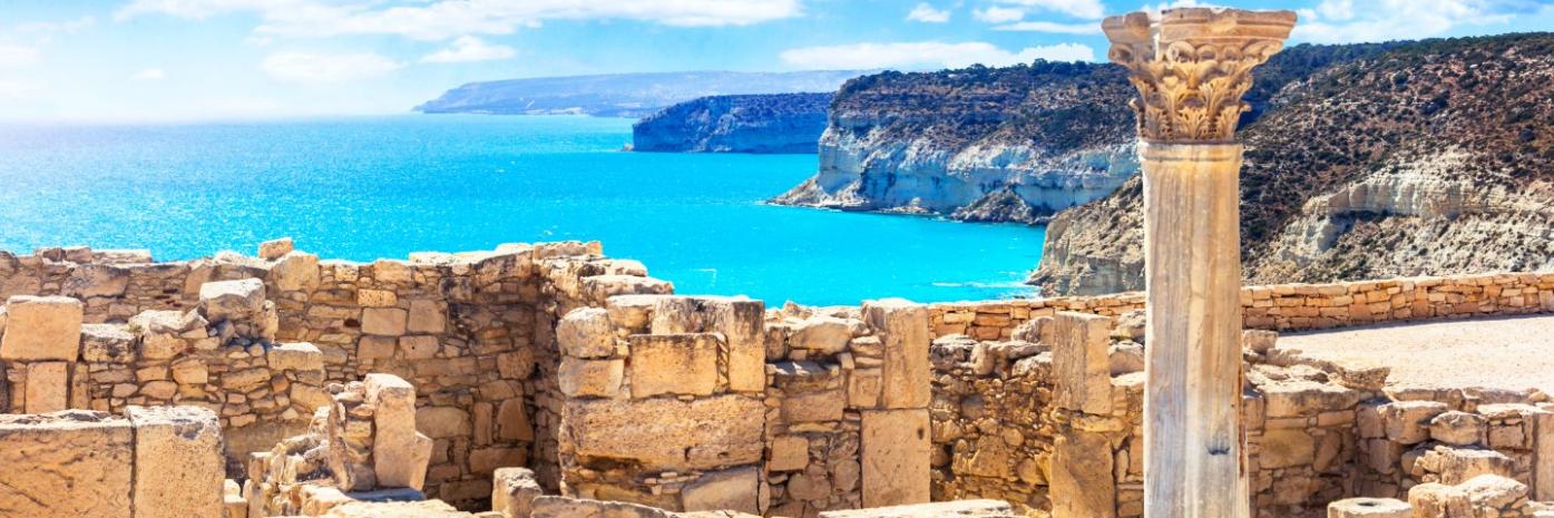 Vibrant blue water behind ancient ruins.
