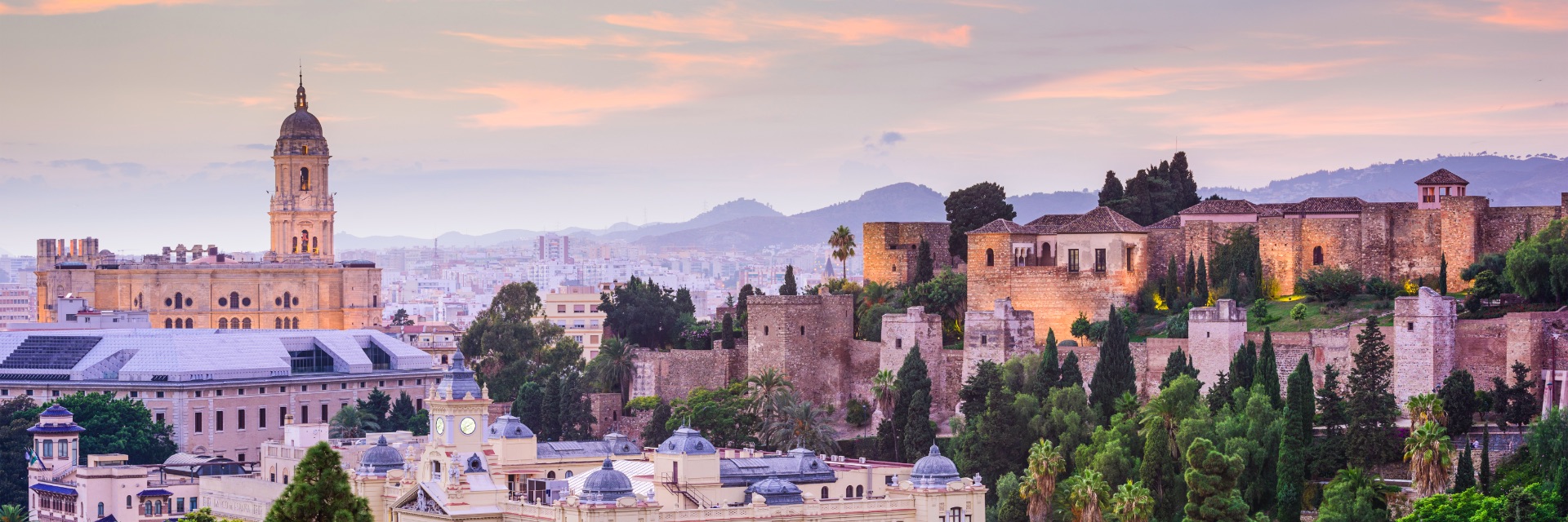 Stone buildings sit atop cliffs in Malaga.