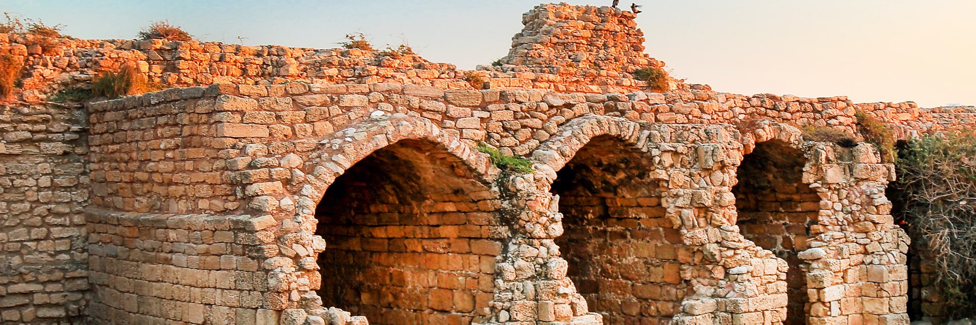 An ancient structure of stones forming arches.