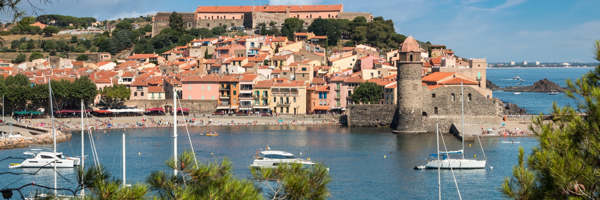 View of the bay and harbor of town perched on a hill.