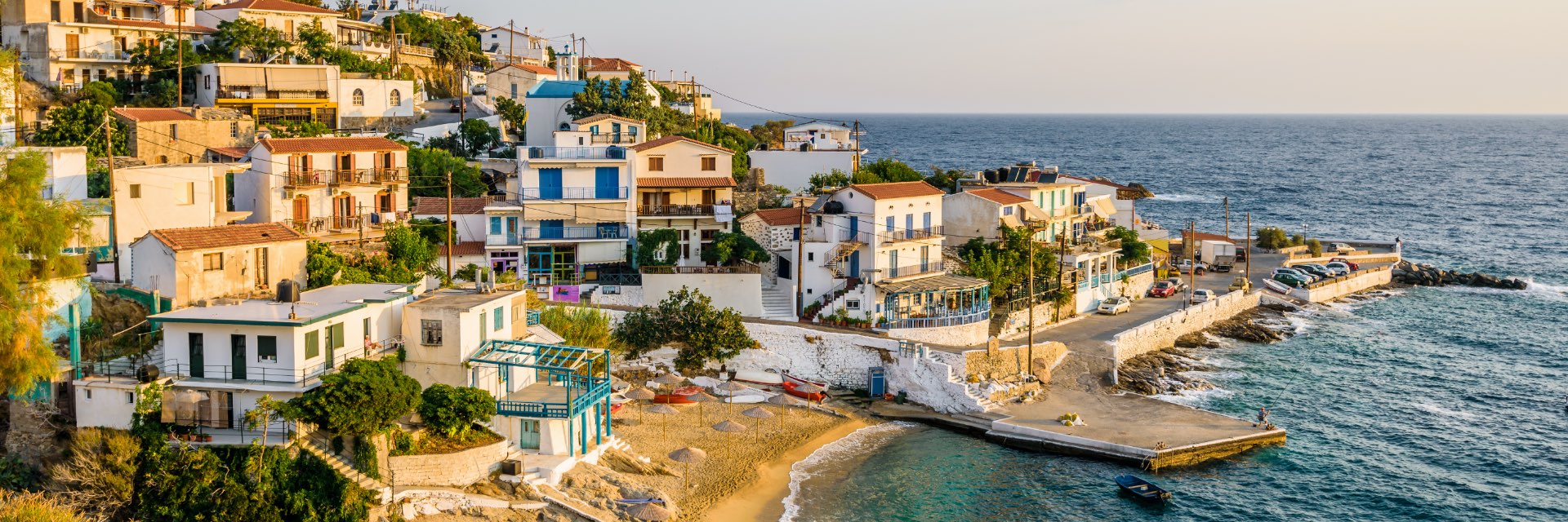 Sun setting on a seaside town perched into a cliff.