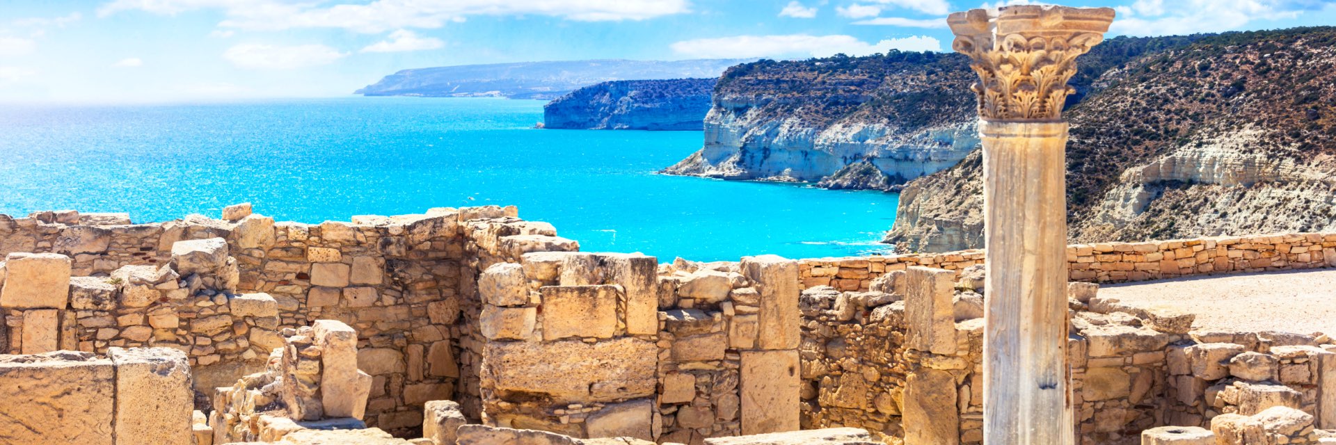Vibrant blue water behind ancient ruins.