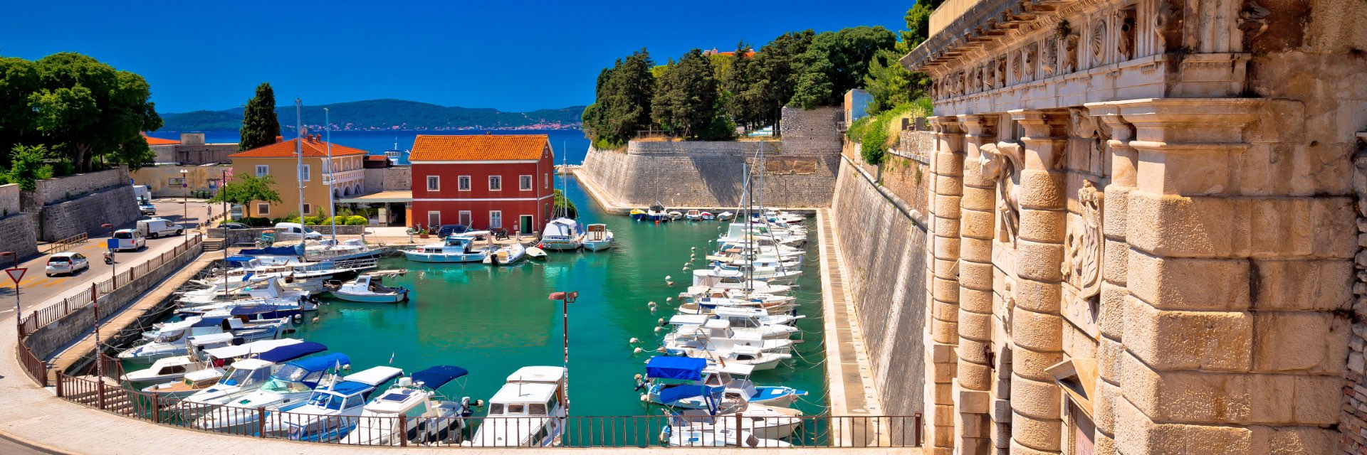 City gate and harbor view on a day with clear blue skies.