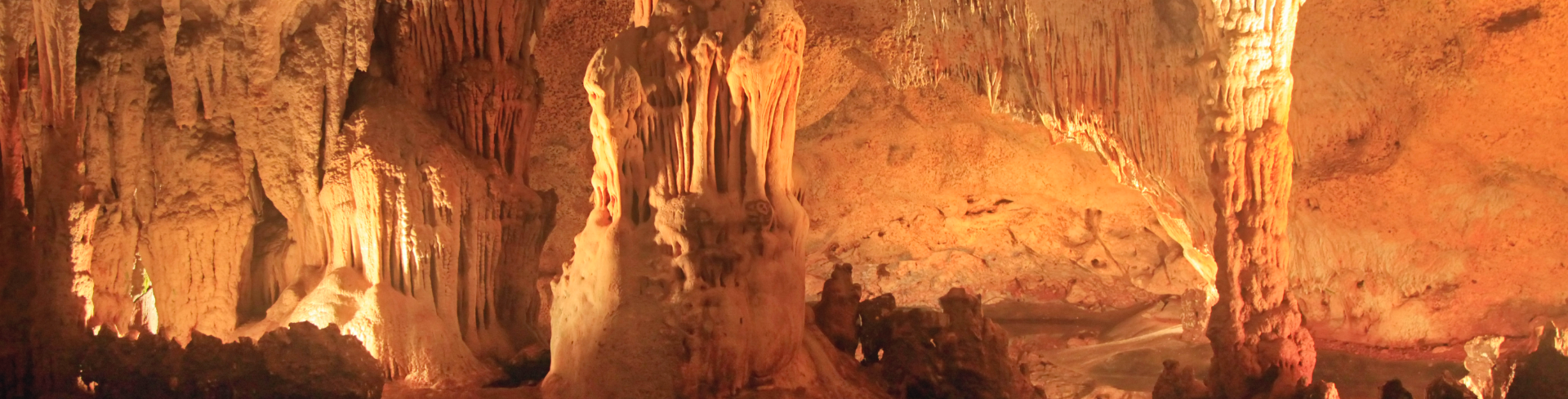 The inside of a cave with huge stalactites.