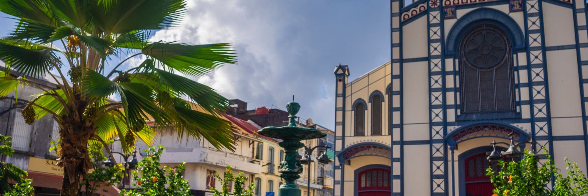 A cathedral in a colonial square decorated with blue adornments.
