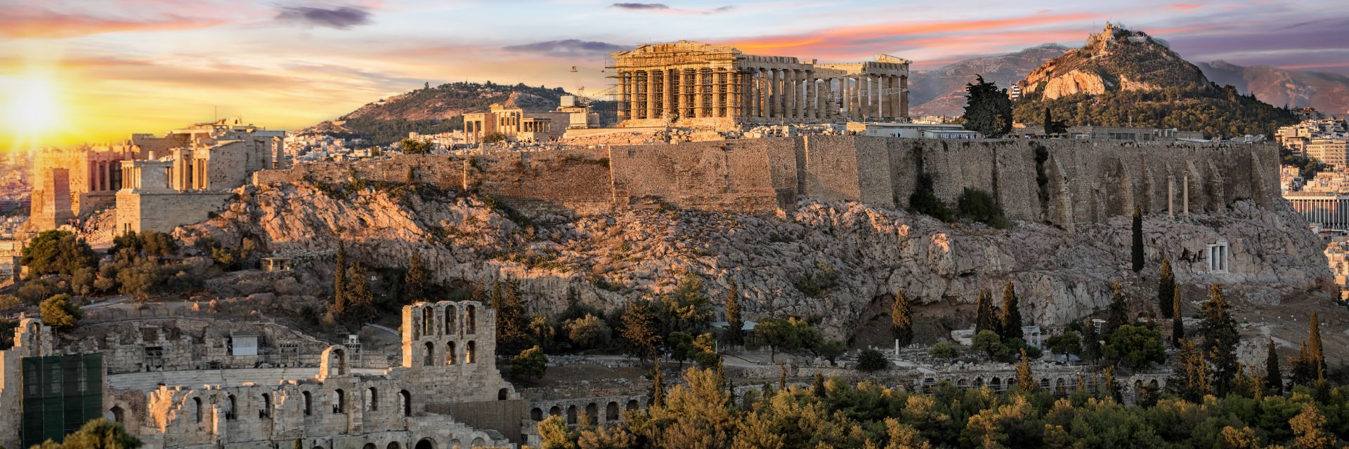 The Acropolis of Athens, Greece, with the Parthenon Temple on top of the hill at sunset.