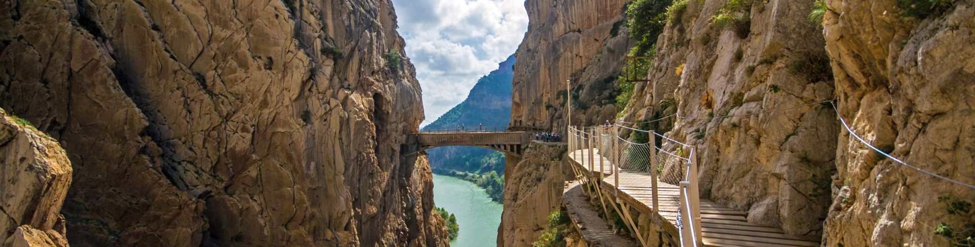 A wooden walkway pinned along the steep walls of a gorge.