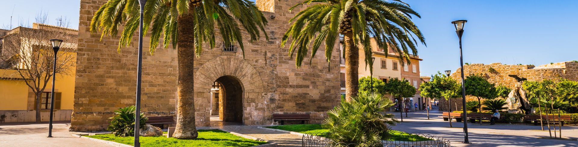  The view of the gate of a fortress wall outside the historic city center of Alcudia.