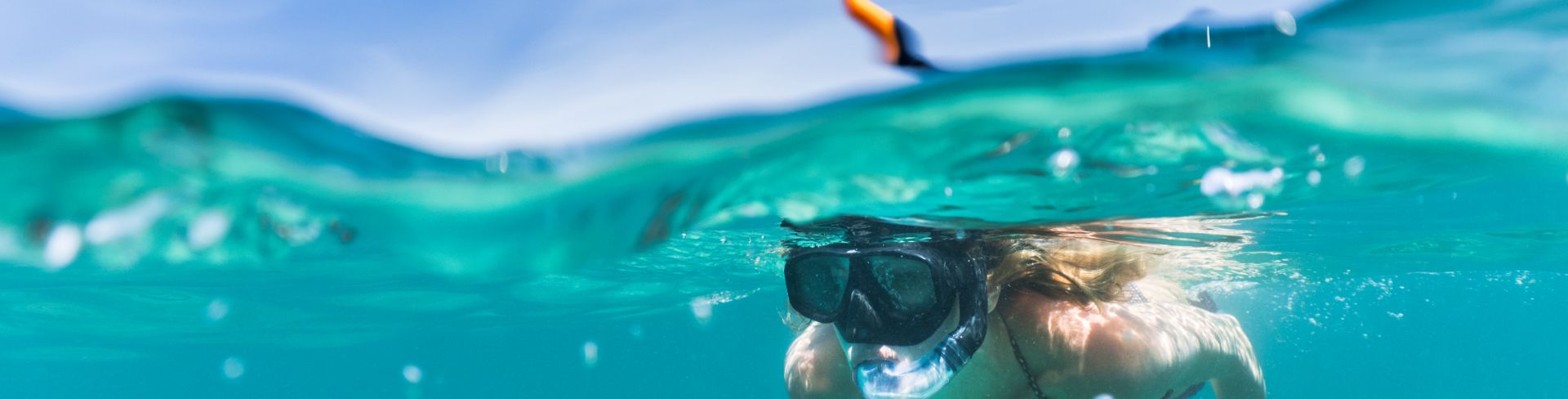 A woman snorkeling underwater.