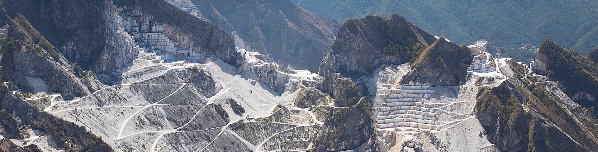 The view of a marble quarry in the mountains in the daytime.