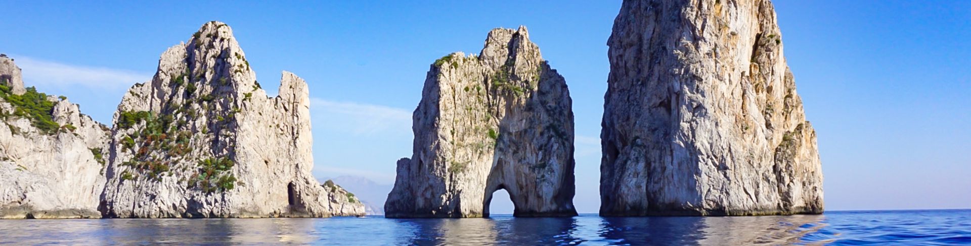 The Faragolini Rock Formations rise out of the sea off the coast of Capri, Italy.