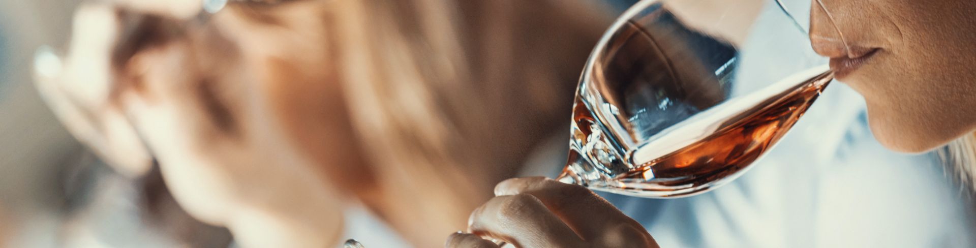 The profile view of a group of people tasting wines.