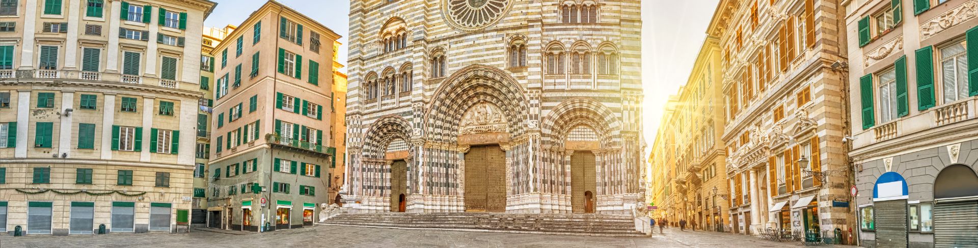 The façade of a cathedral designed in the Romanesque and Gothic styles.