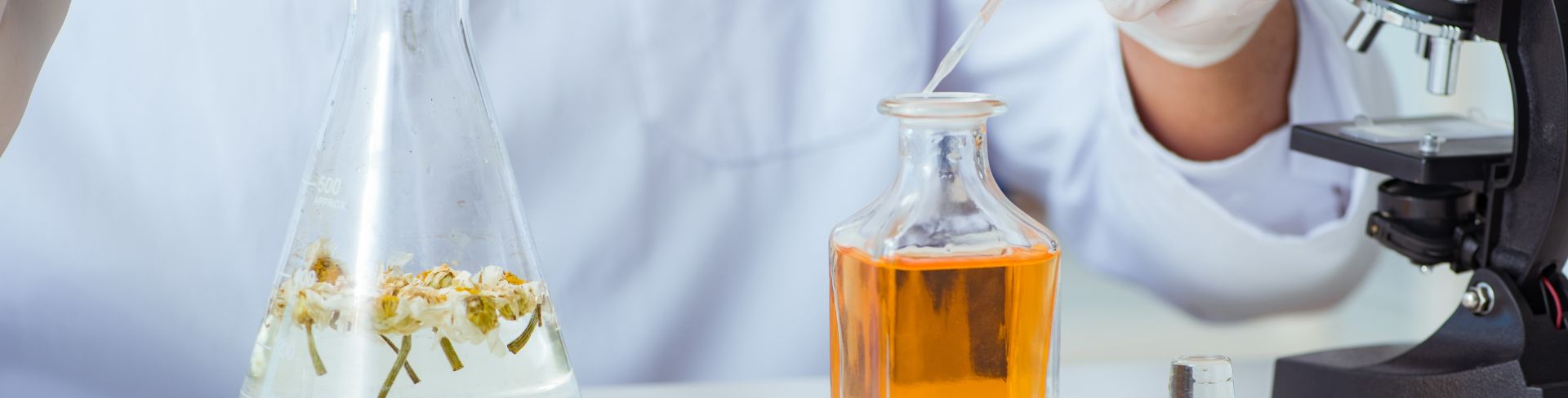 A chemist mixes perfumes in a lab.