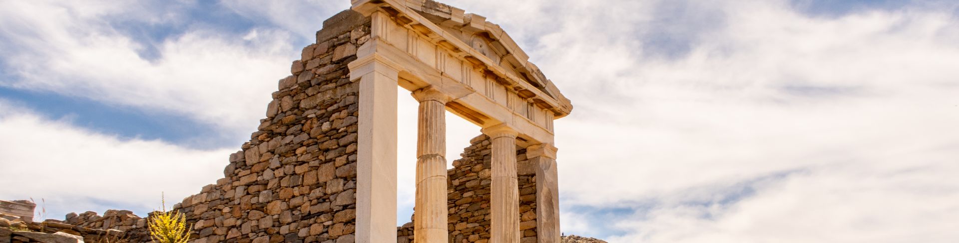 The ruins of an ancient temple on a hillside in Greece.