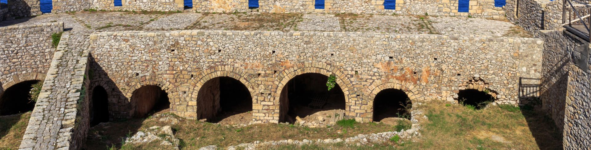 The view of a bay from inside a fortress, looking over the battlements.