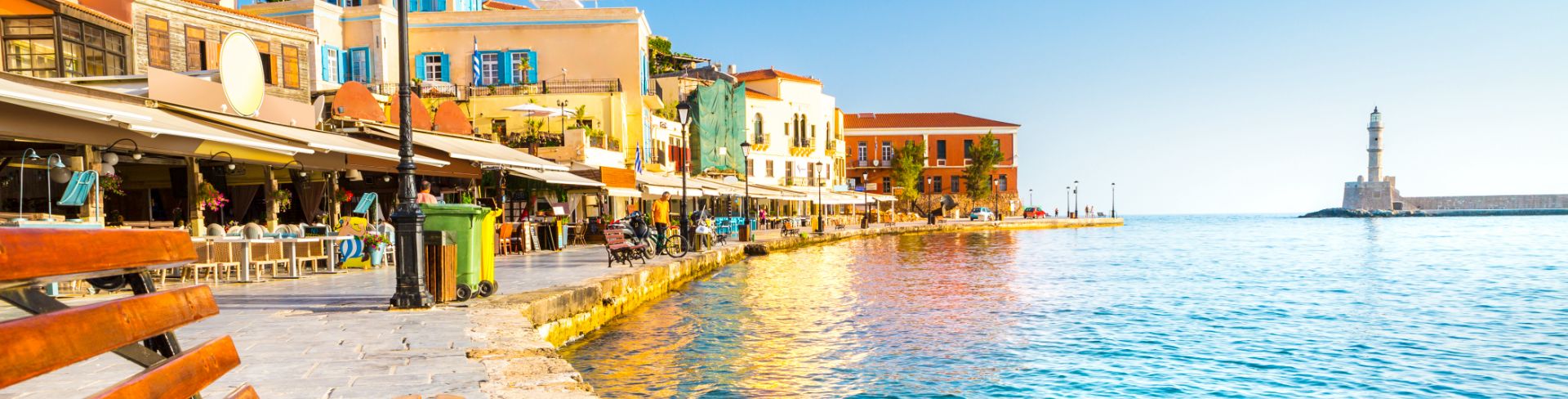 A Venetian style harbor in Chania, Crete, lined with shops and eateries.