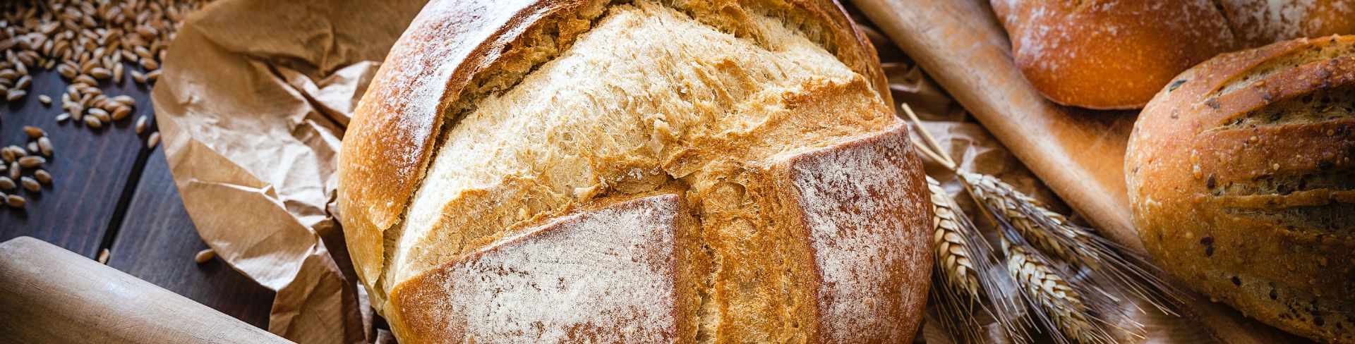Loaves of freshly baked bread rest on a table.