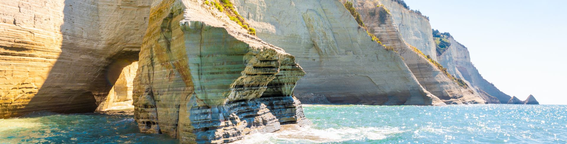 The view of stacks and cliffs close to a crystal clear sea.