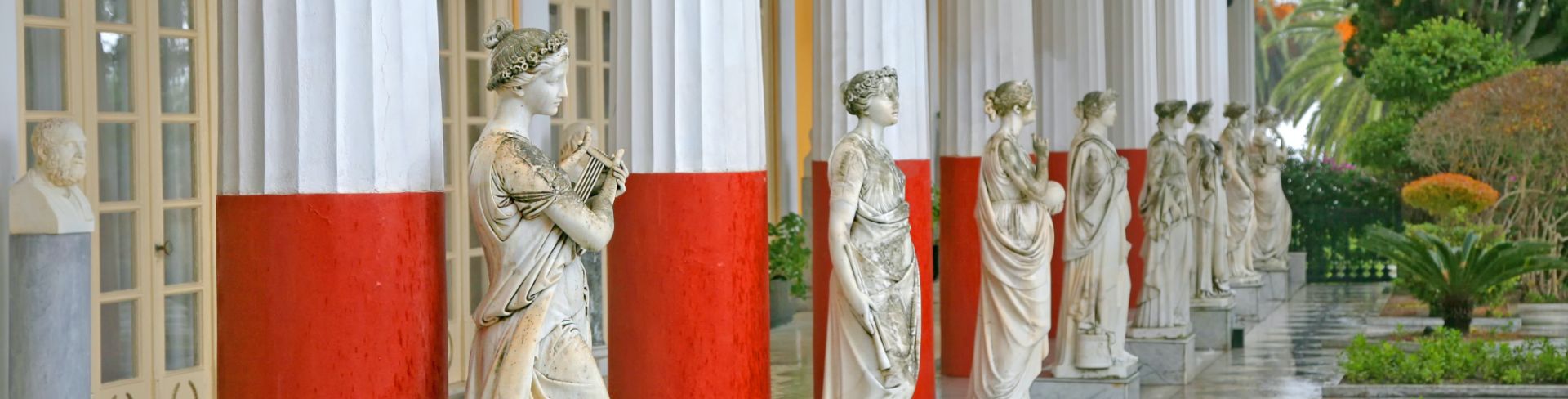 Statues line the Achilleion Palace walls in Corfu.