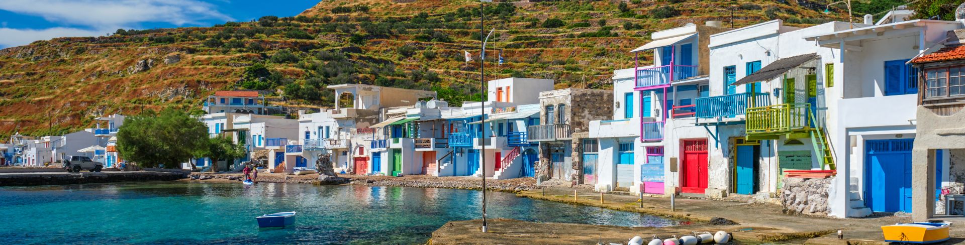 Colorful historic buildings sit at the waters edge. 
