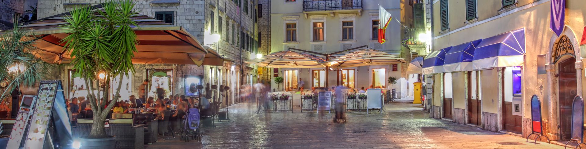 Lights illuminate the town's street and the nearby mountainside. 