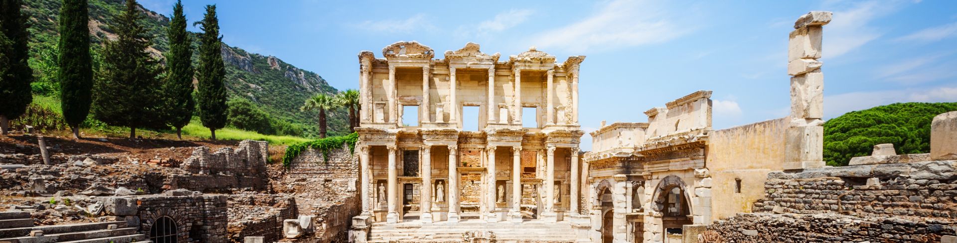 Ancient Catholic ruins sit under the bright blue sky in Ephesus, Turkey. 