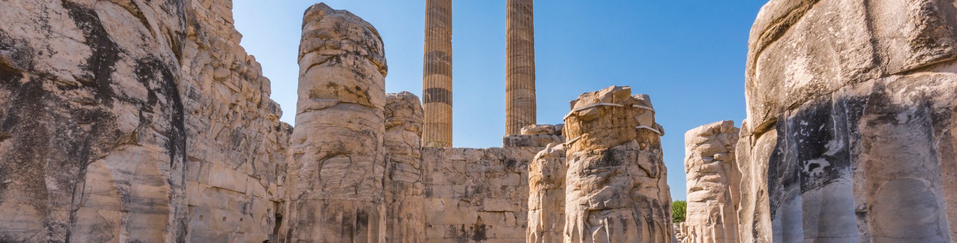 The ancient Greek Temple of Apollo sits under the blue sky in Didyma.