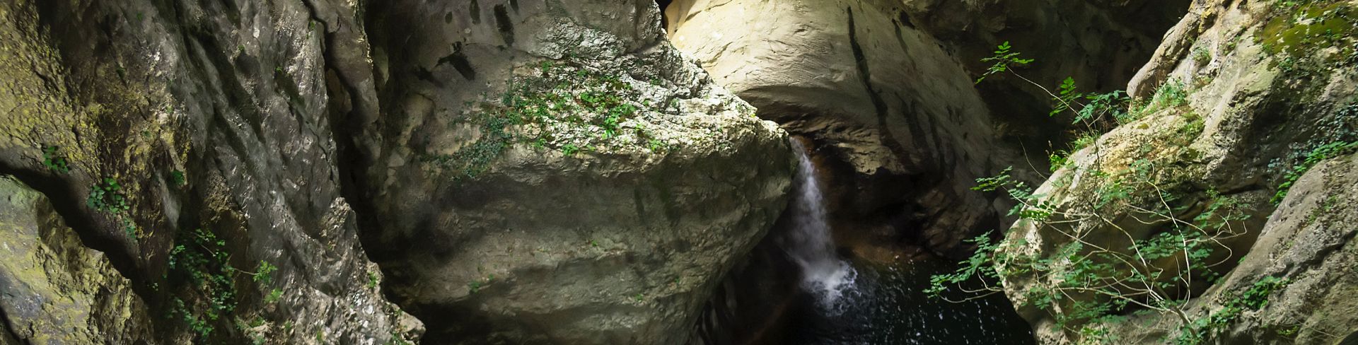 A waterfall tumbles into the bottom of the cave. 