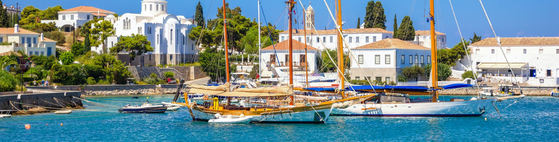Sail boats at anchor in the harbor of Spetses, Greece.
