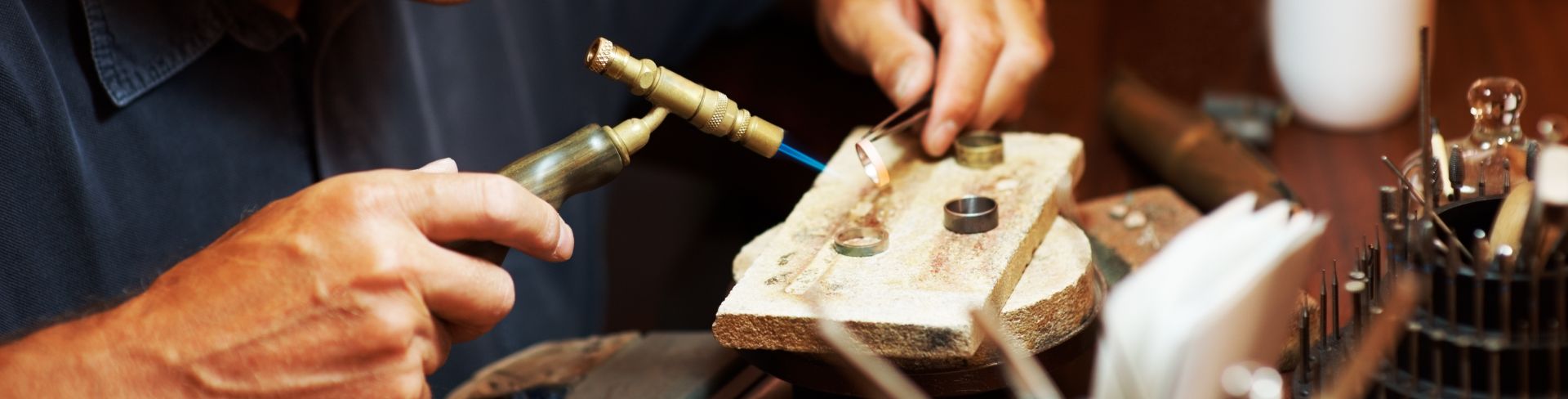 A jeweler works on a set of rings.