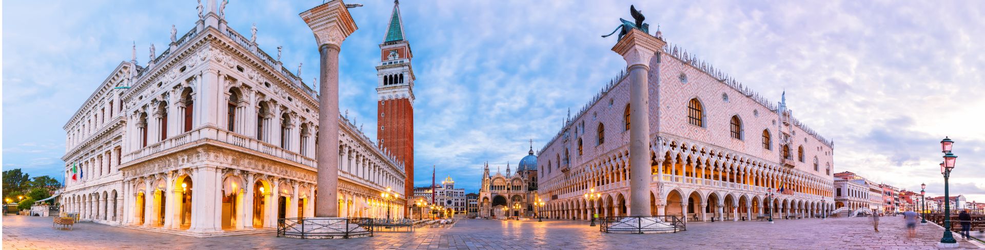 A panoramic view of Piazza San Marco, including the Column of San Teodoro, National Library, Doge's Palace and St. Mark's Basilica.