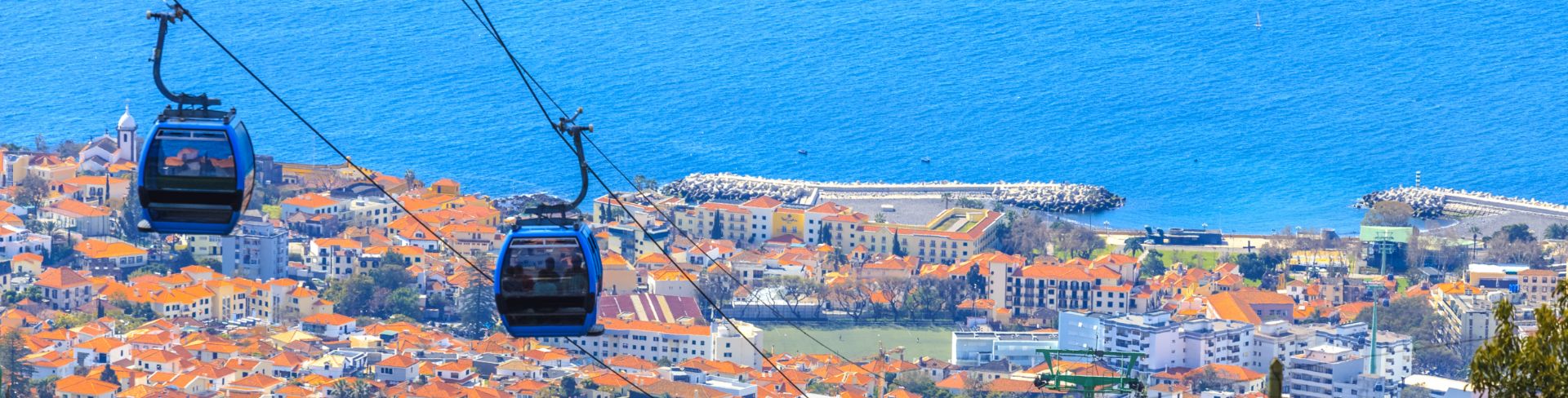 Two cable cars above the cityscape of Funchal, the capital of Madeira.