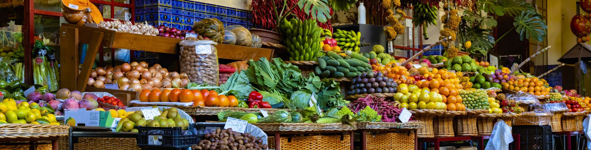 Open-air food stalls full of a wide variety of colorful and fresh produce.