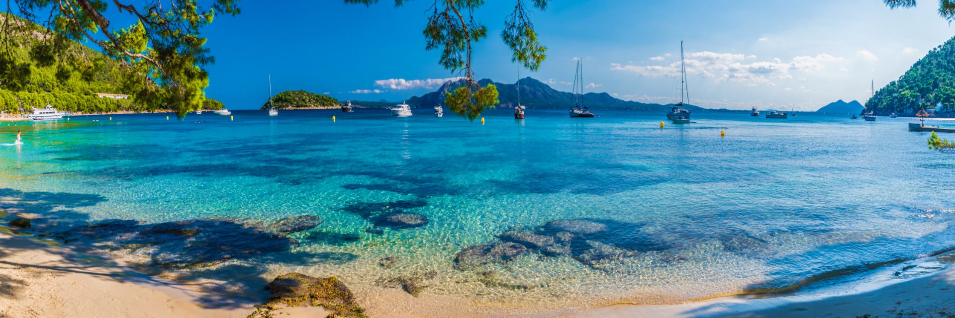 Bright blue waters dotted with boats.