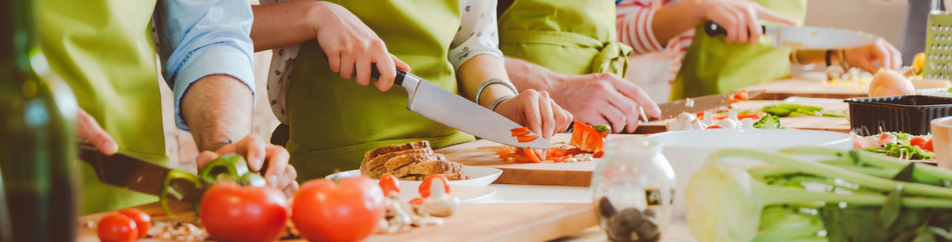 Students of a cooking class cut vegetables together