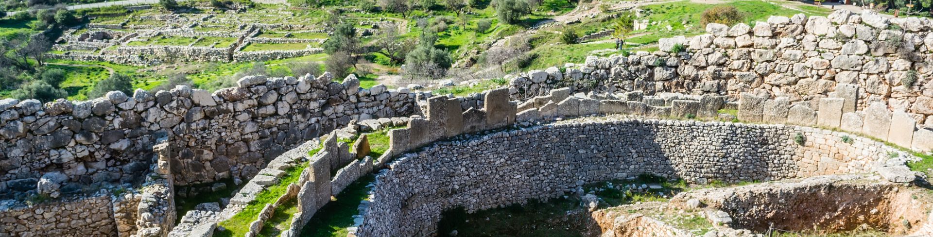 Expanse of ancient ruins with mountains in the distance