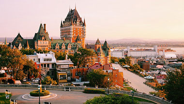 A warm orange historic building at dusk.