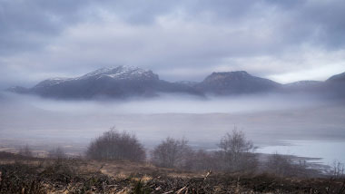 A cloudy, hazy mountainous landscape.
