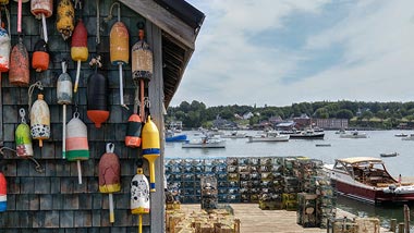 Fishing supplies hang on the side of a shack perched at the dock.