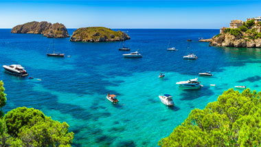 Turquoise water filled with boats.